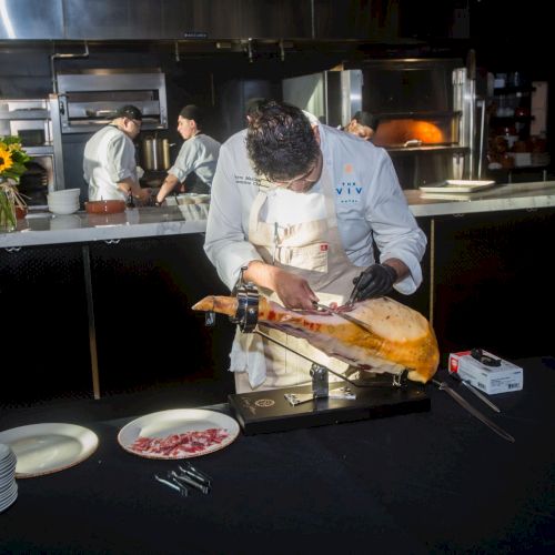 A cluttered living room with a person sitting on the floor surrounded by toys, clothes, and scattered items at a low table.